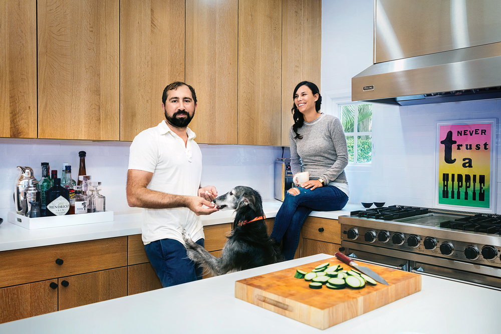 Chris and Kristen Vila relax in their Palm Beach home with their dog, Steve.