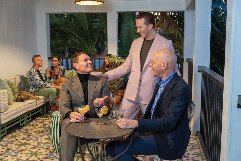 Miller and Sweeney mingle with guests including Joseph Singer on the second-floor veranda, which features colorful Spanish tiles. Photography by Jerry Rabinowitz