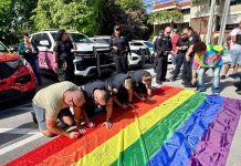 Signing the Pride flag at the first annual Historic Stonewall Uprising Reenactment. Photo courtesy of Stonewall National Museum, Archives, & Library