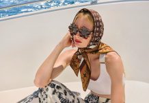 Louis Vuitton sports bra, jogging pants, scarf, handbag; Valentino sandals; Bottega Veneta sunglasses