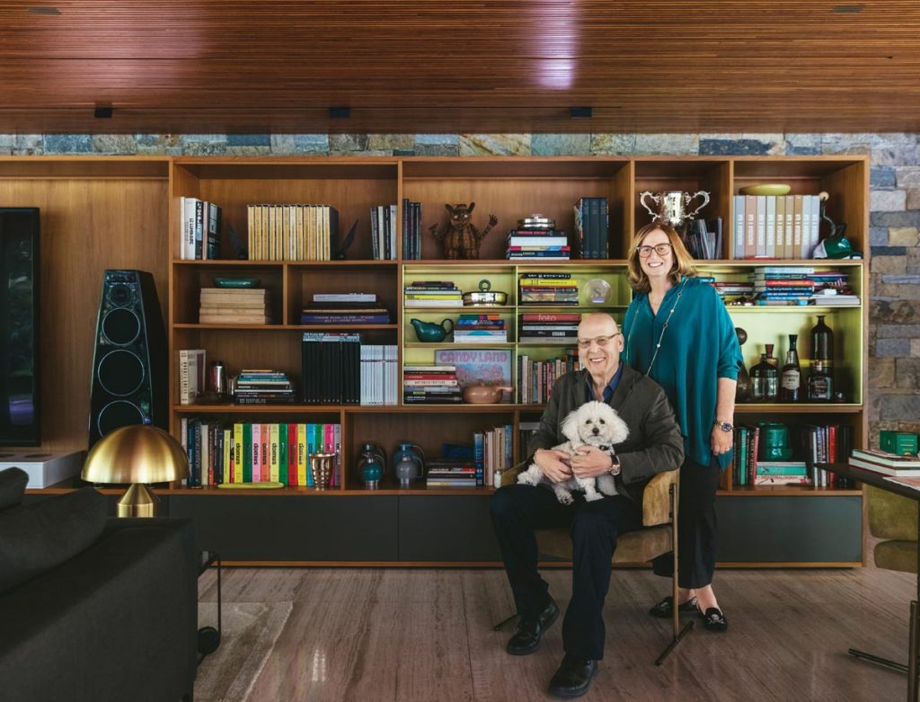 The Glazers are pictured at their Palm Beach home with their dog, Eloise. In 2020, the Preservation Foundation of Palm Beach recognized this home (designed by Marcio Kogan) with the Elizabeth L. and John H. Schuler Award. Photo by Nick Mele